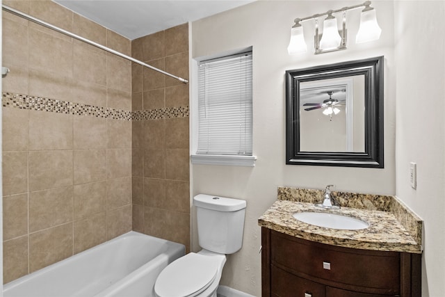 full bathroom with vanity, tiled shower / bath, toilet, and ceiling fan