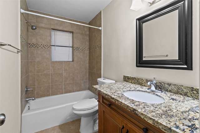 full bathroom featuring vanity, toilet, tile patterned floors, and tiled shower / bath