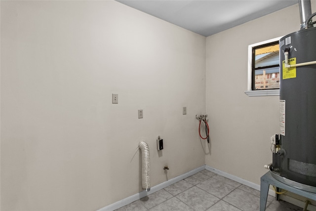 laundry room with hookup for a washing machine, light tile patterned flooring, and gas water heater