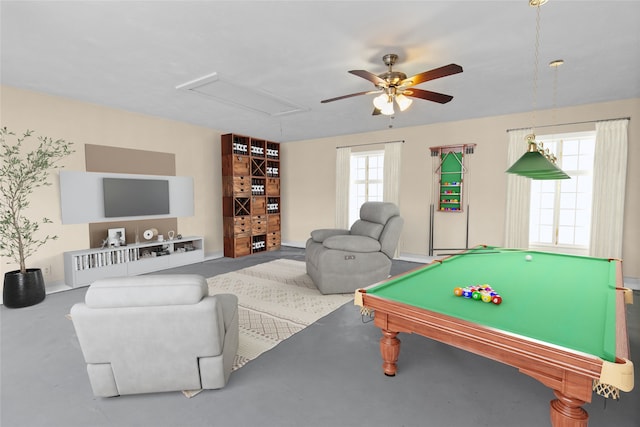 playroom featuring concrete floors and ceiling fan