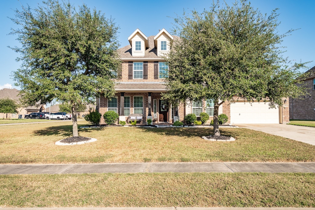 view of front of property with a front lawn and a garage