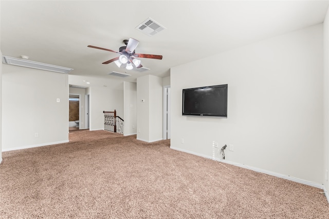 unfurnished living room featuring carpet and ceiling fan