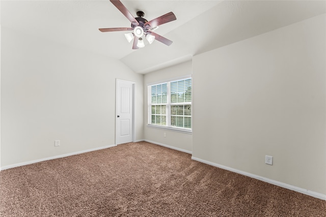 carpeted empty room featuring vaulted ceiling and ceiling fan