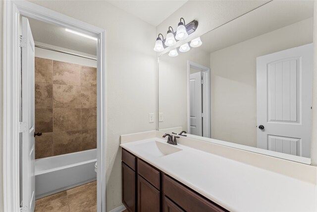 full bathroom with vanity, toilet, tile patterned flooring, and tiled shower / bath