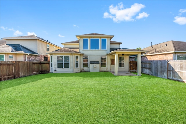 rear view of property featuring a patio area and a lawn