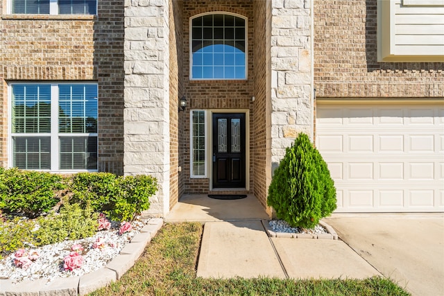 doorway to property featuring a garage