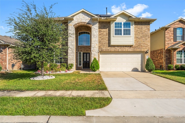 view of front of property featuring a front lawn and a garage