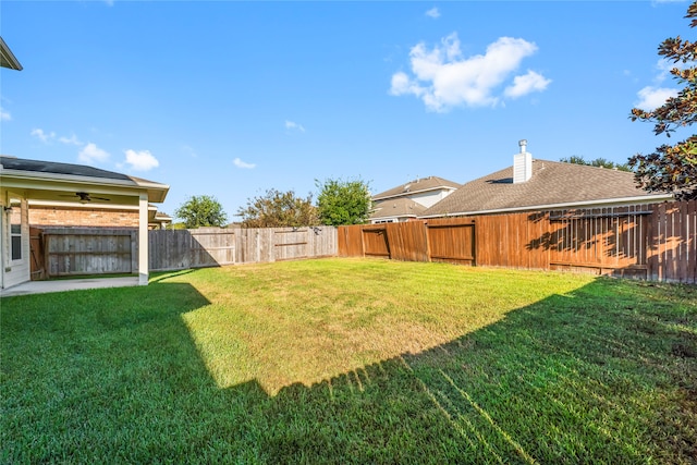 view of yard featuring a patio and ceiling fan