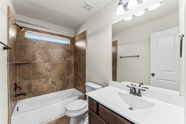 full bathroom featuring toilet, tiled shower / bath combo, and vanity