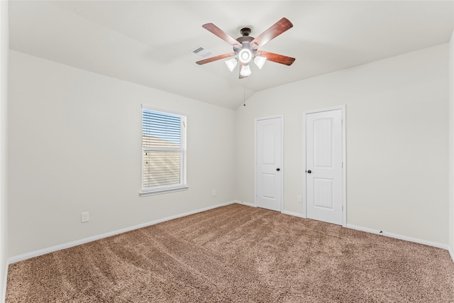 unfurnished bedroom featuring ceiling fan, lofted ceiling, and carpet floors