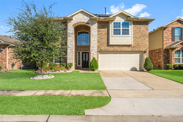 view of front of home with a front yard and a garage