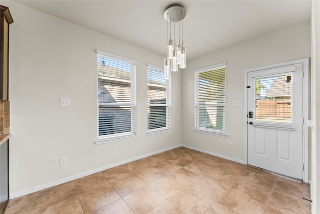 unfurnished dining area featuring light tile patterned floors