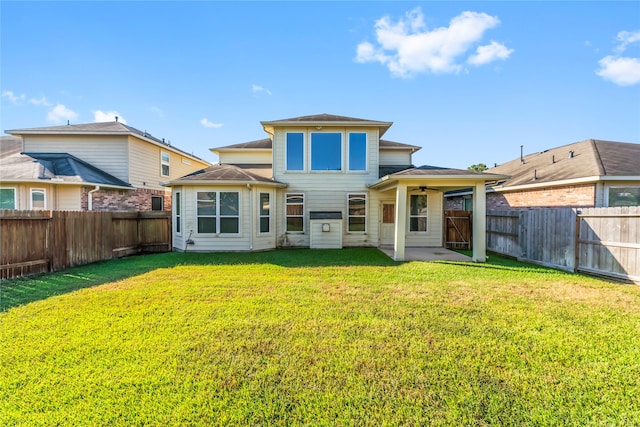 back of property with a yard and a patio