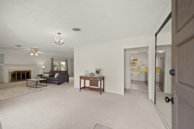 living room with crown molding, light carpet, a textured ceiling, and ceiling fan with notable chandelier