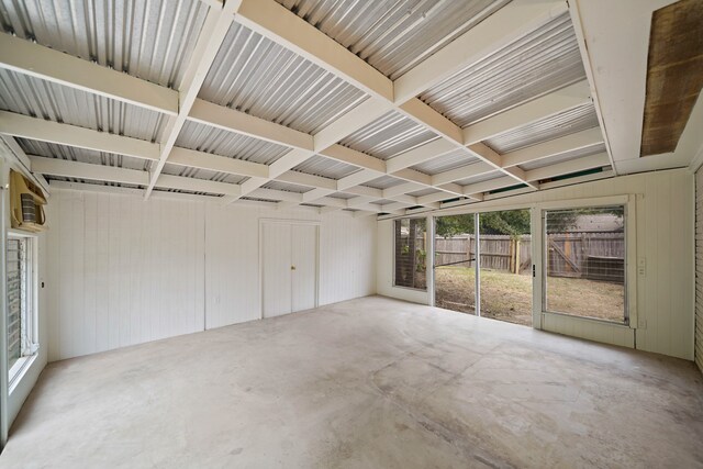 unfurnished sunroom with beam ceiling