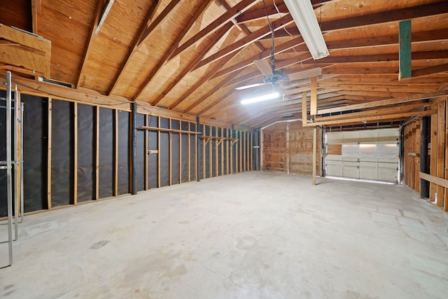 interior space featuring concrete floors and vaulted ceiling