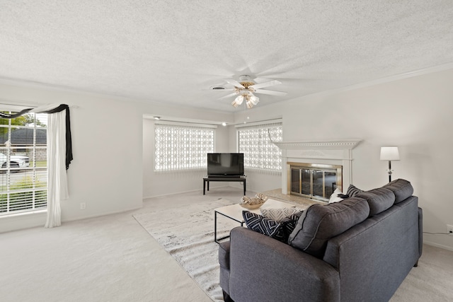 carpeted living room featuring crown molding, a textured ceiling, and a wealth of natural light