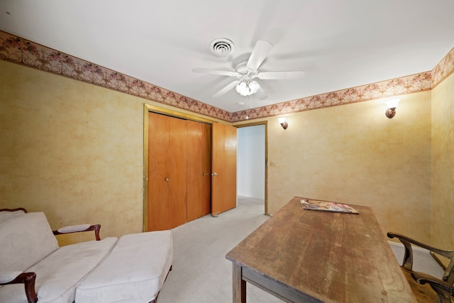 office space with light colored carpet and ceiling fan