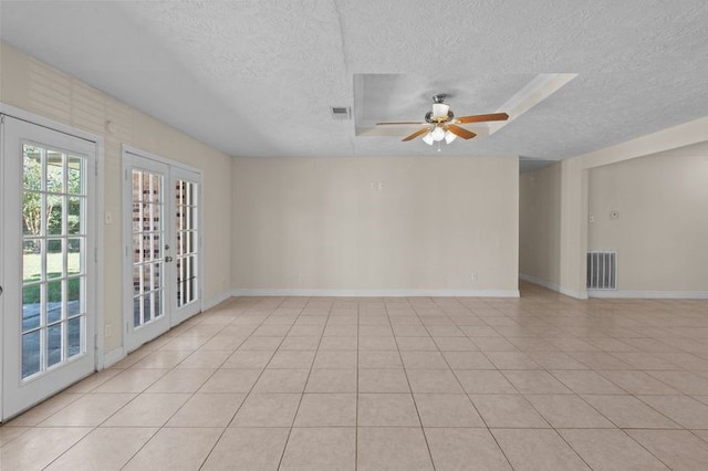 unfurnished room with french doors, a textured ceiling, light tile patterned floors, and ceiling fan