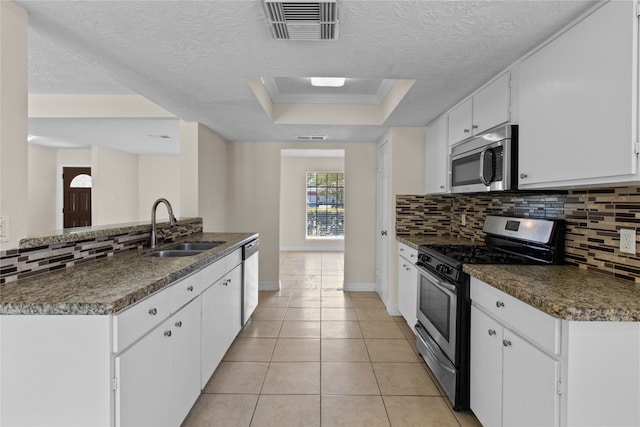 kitchen featuring tasteful backsplash, appliances with stainless steel finishes, white cabinetry, crown molding, and sink