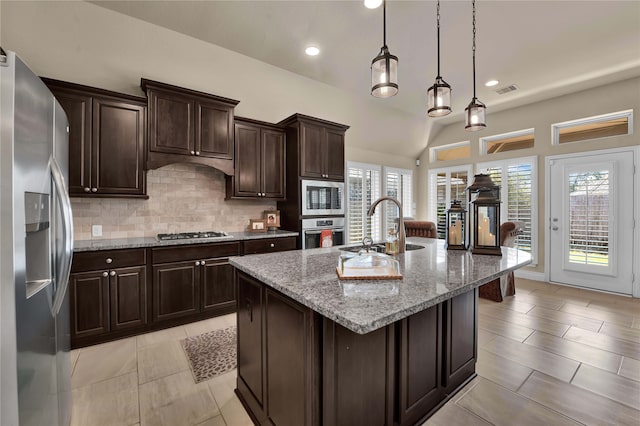 kitchen featuring appliances with stainless steel finishes, sink, a center island with sink, and plenty of natural light