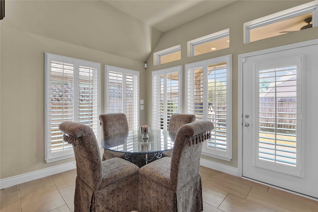 dining room featuring light tile patterned floors, a healthy amount of sunlight, and lofted ceiling