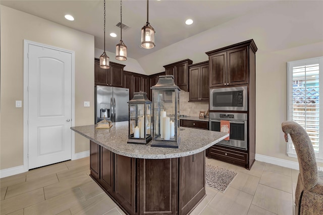 kitchen with stainless steel appliances, dark brown cabinetry, a center island, and hanging light fixtures