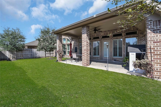 rear view of house featuring a patio area, a lawn, and ceiling fan