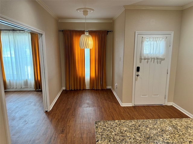 entrance foyer with ornamental molding, wood-type flooring, and a healthy amount of sunlight