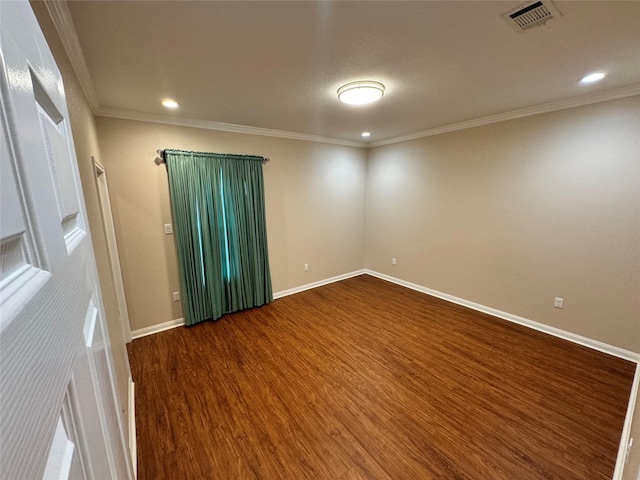 spare room featuring ornamental molding and hardwood / wood-style floors