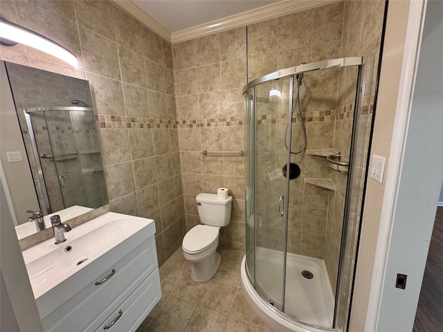 bathroom with toilet, a shower with shower door, vanity, crown molding, and tile patterned floors