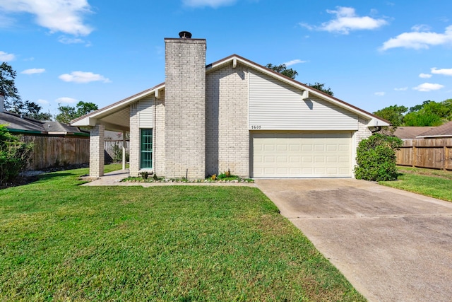 back of house with a yard and a garage