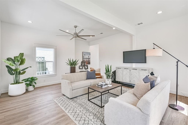 living room with light hardwood / wood-style flooring and ceiling fan