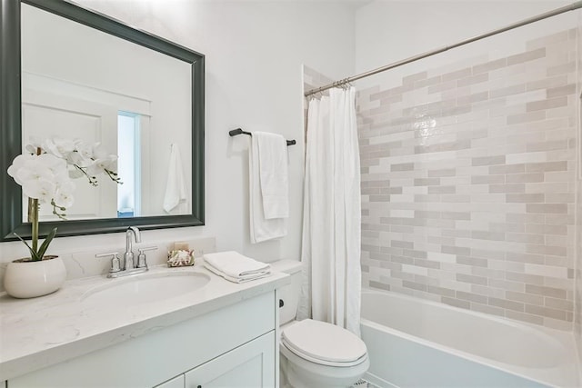 full bathroom with vanity, shower / bath combo, and toilet