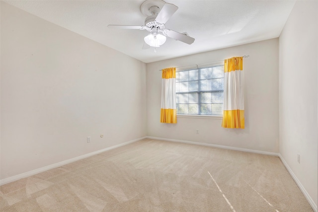 empty room featuring light carpet and ceiling fan