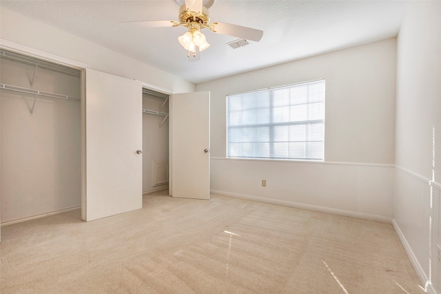 unfurnished bedroom with light colored carpet and ceiling fan