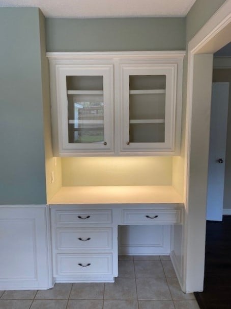 details with built in desk and tile patterned flooring