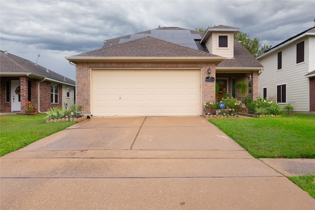 view of front of property featuring a garage and a front lawn