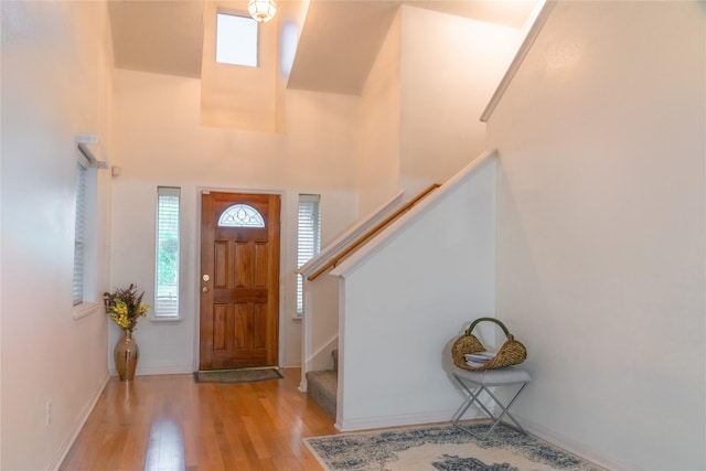 5618 Tiger Lilly Way, Houston, TX 77085 - foyer entrance with healthy amount of natural light, wood finished floors, stairway, and baseboards