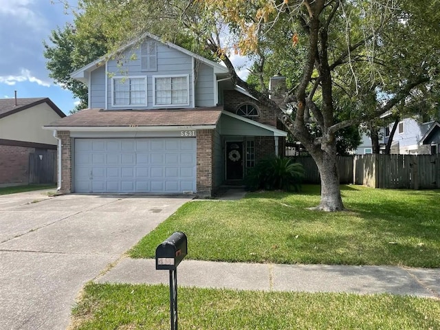 view of property with a garage and a front lawn