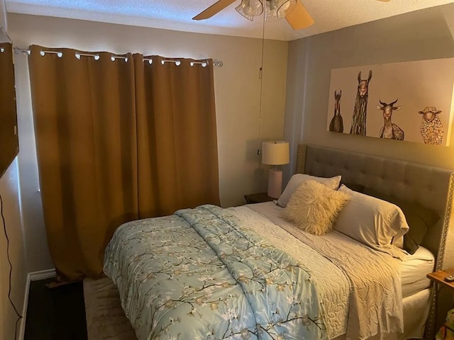 bedroom with a textured ceiling and ceiling fan