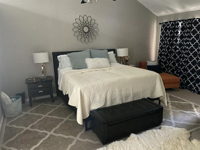 bedroom featuring ceiling fan, carpet flooring, and lofted ceiling