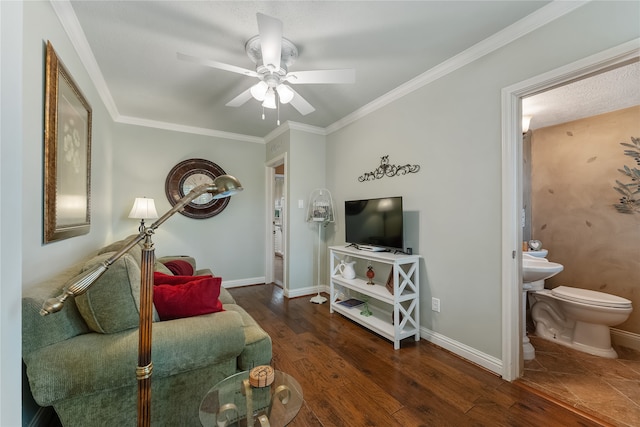 living room featuring dark hardwood / wood-style floors, ceiling fan, and crown molding