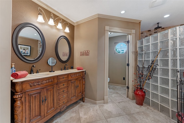 bathroom with tile patterned floors, vanity, toilet, and ornamental molding