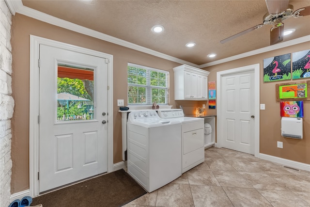 washroom featuring cabinets, ceiling fan, ornamental molding, a textured ceiling, and washing machine and clothes dryer