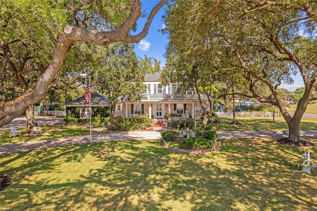 obstructed view of property featuring a front yard and a balcony