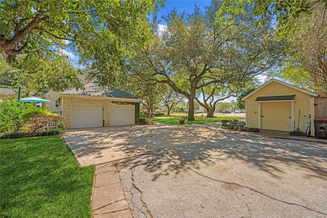 exterior space with a detached garage and an outdoor structure