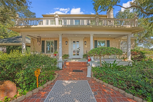 view of front of home featuring covered porch and a balcony