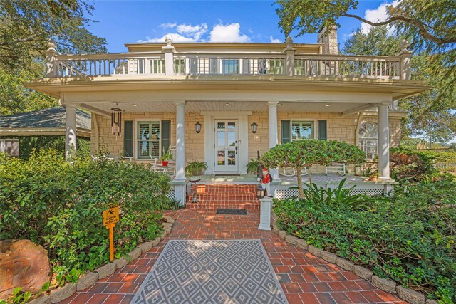 view of front of home with a balcony and a porch