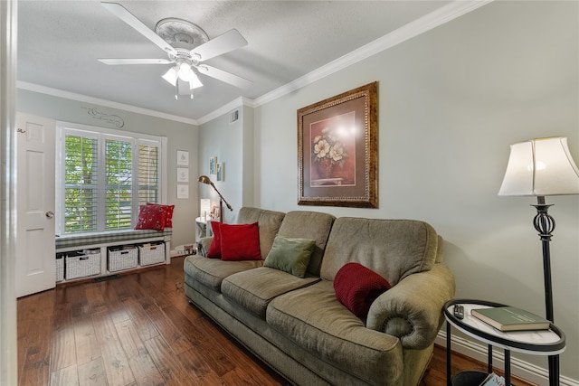 living room featuring a textured ceiling, dark wood-type flooring, a ceiling fan, visible vents, and crown molding